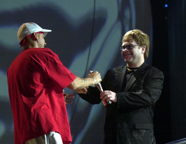 Sir Elton John (right) presents the award for Best International Male Solo Artist to American rap star Eminem,