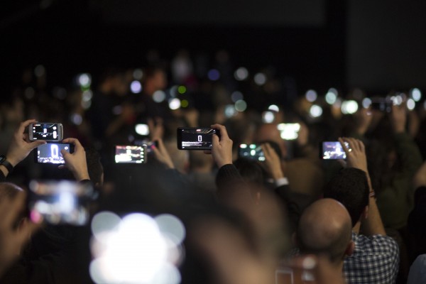 Attendances use their phones to take images of the new G6