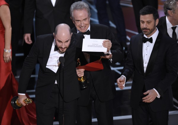 La La Land producer Jordon Horowitz, Warren Beatty and Jimmy Kimmel during the Oscars mix-up ( Chris Pizzello/AP)