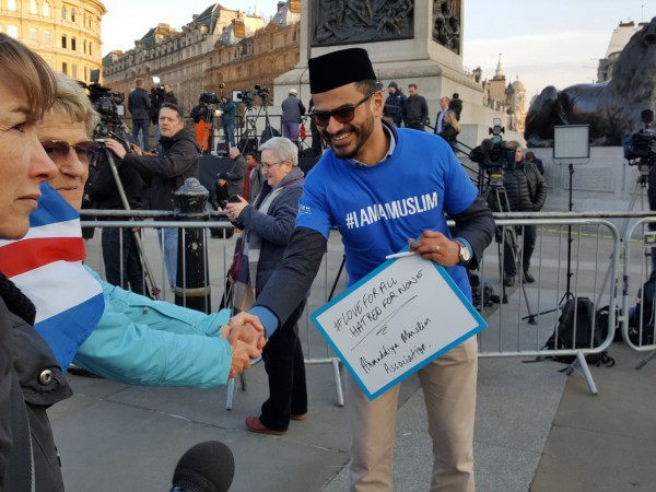 A woman stops to shakes hands