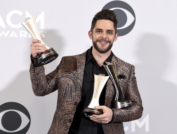 Thomas Rhett poses in the press room with his awards for artist and songwriter for song of the year for "Die A Happy Man," and male vocalist of the year at the 52nd annual Academy of Country Music Awards at the T-Mobile Arena on Sunday, April 2, 2017, in Las Vegas. (Photo by Jordan Strauss/Invision/AP)
