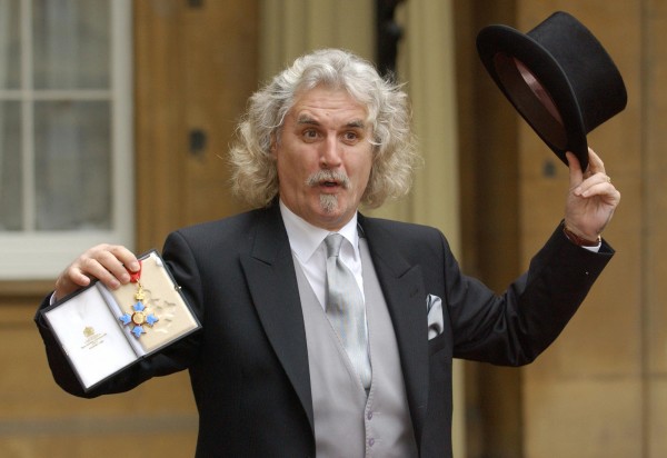 Billy Connolly, the Scottish comedian and actor, shows off his CBE, which he collected today from the Prince of Wales at Buckingham Palace, London. (Fiona Hanson/PA Archive/PA Images)