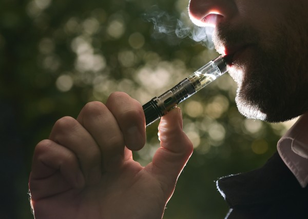 a man smoking an electronic cigarette