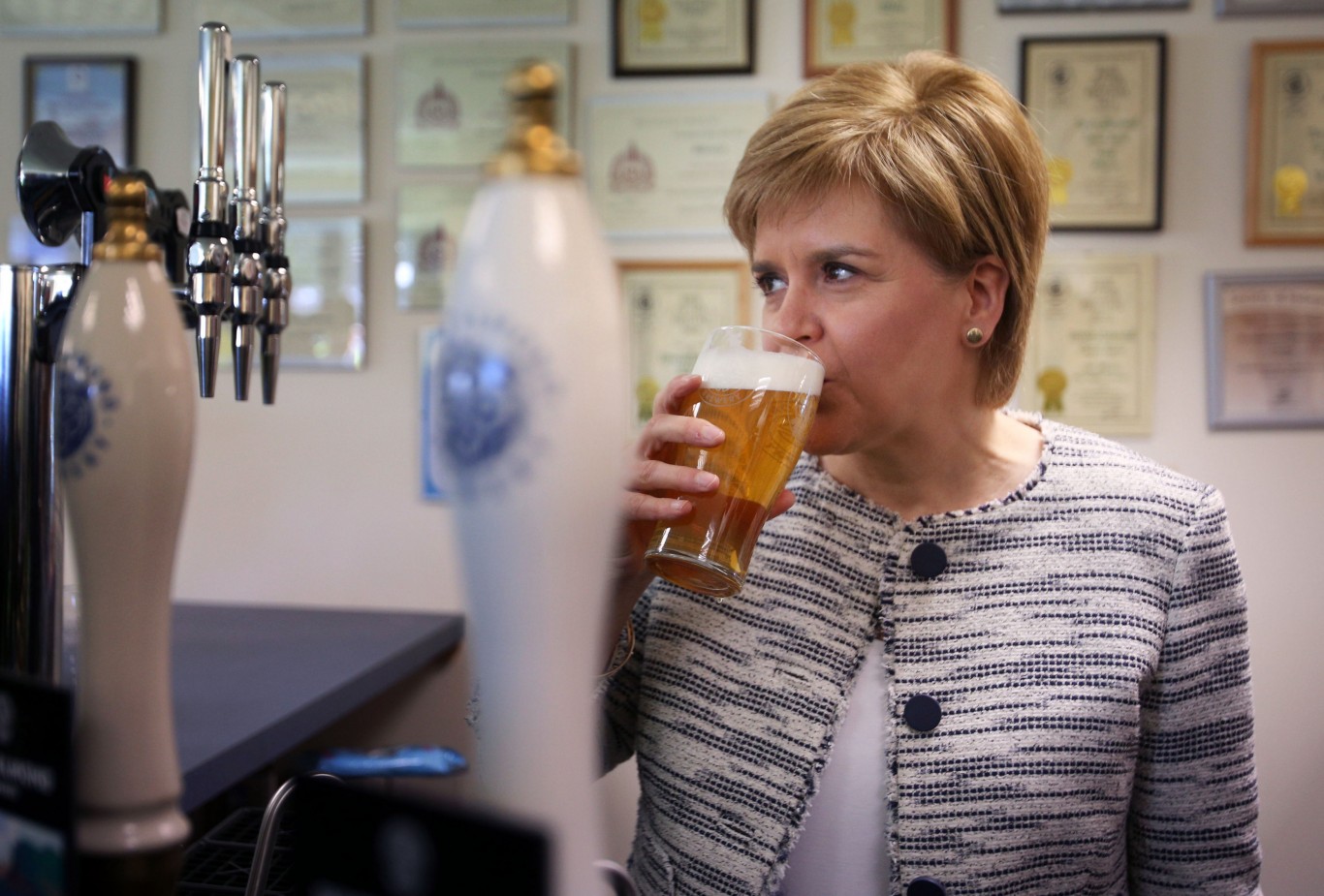 First Minister Nicola Sturgeon drinks a pint (David Cheskin/PA)