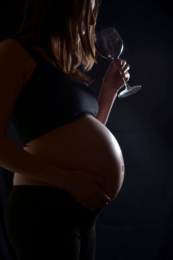 Pregnant woman with glass of wine