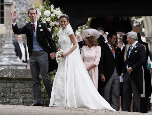 Pippa Middleton and James Matthews smile for the cameras after their wedding at St Mark's Church (Kirsty Wigglesworth/AP)