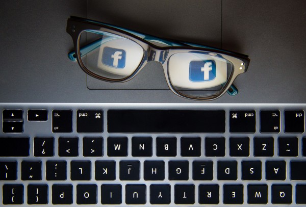 Facebook's logo reflected in a pair of glasses