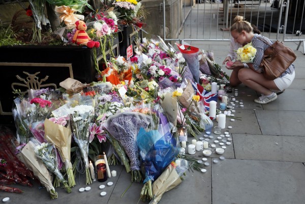 Vigils Held Across Uk For Victims Of Manchester Terror A Child Places Flowers At Memorial Site For The Victims Of