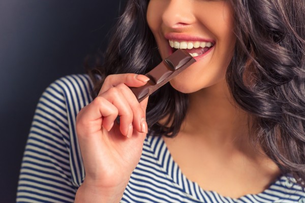 Woman eating chocolate.