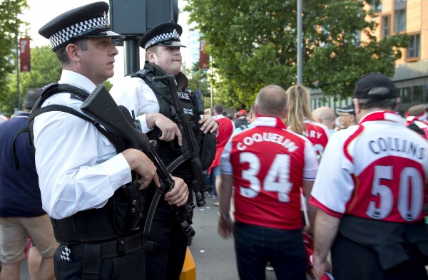 Armed police officers patrol outside Wembley Stadium.