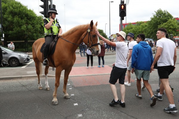 Music fans interact with a mounted police officer at Lancashire Cricket Club's Old Trafford ground, (Jonathan Brady/PA)
