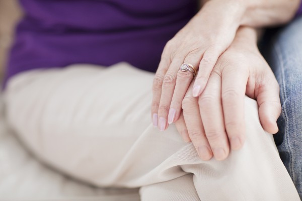 Married couple holding hands.