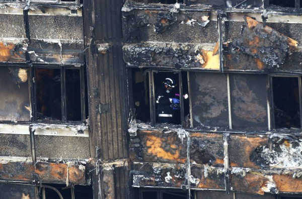 Fire service personnel survey the damage (Rick Findler/PA)