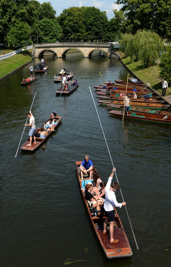 People relax in punts along the River Cam in Cambridge (Joe Giddens/PA)