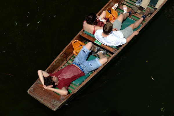 People relax in punts along the River Cam in Cambridge (Joe Giddens/PA)